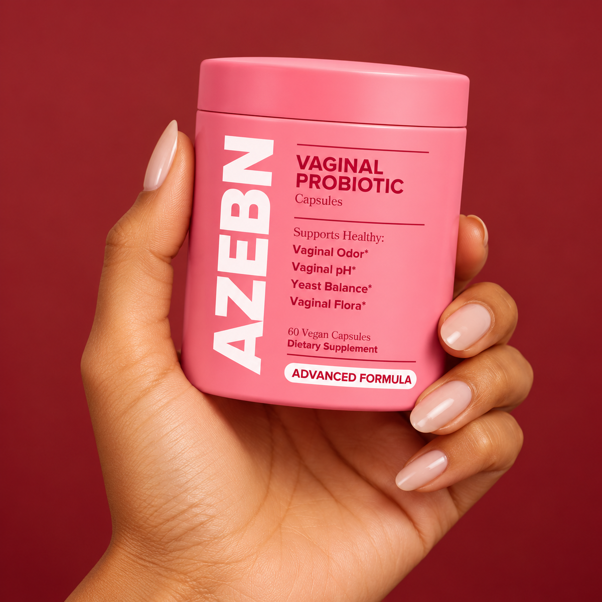 AZEBN women's probiotic capsules jar held in hand against a berry backdrop